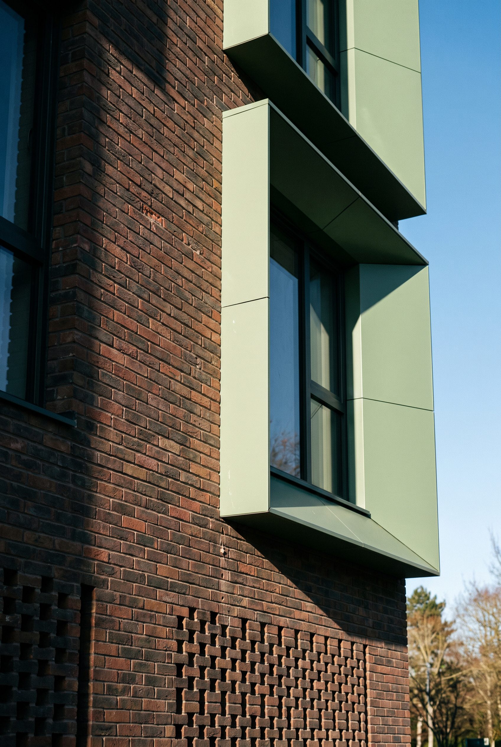 Close detail of brick reveal and sage green window surround